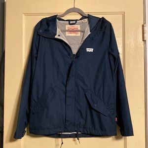 Levi’s Men’s navy blue windbreaker jacket with mesh lining and hoodie.